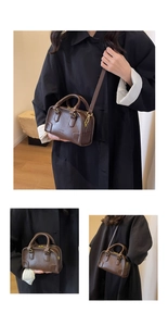 Detailed macro view of the vintage brown litchi leather bag with embossed logo and metal hardware