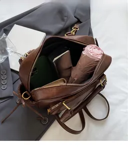 Top view of brown leather bag interior showing spacious capacity for daily essentials