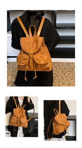 Detail of vintage suede backpack showing texture, front pockets and leather straps