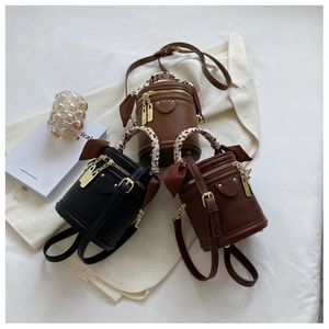Vintage mini bucket bag with leopard scarf handles in black, dark brown, and tan leather