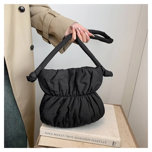 Detailed view of the black nylon pleated padded shoulder bag, cloud dumpling design, stylish.