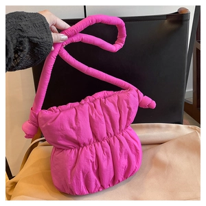 Detailed view of the pink puffer shoulder bag showing soft nylon pleated texture.