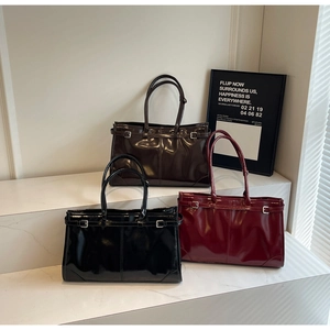 Three glossy oil-wax leather tote bags in black, dark brown, and burgundy finishes