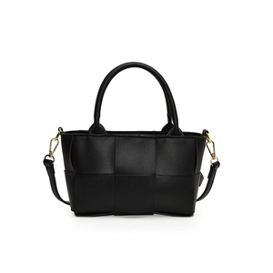 Fashionable black woven crossbody bag with cylindrical handles and gold metal hooks
