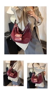 Detail of wine red hobo bag featuring mixed suede leather and a small chain pouch accessory