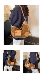 Detail of vintage brown suede moon bag with chain pendant in home setting view