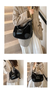 Detail of black patchwork bucket bag featuring matte leather, suede and a mini chain pouch