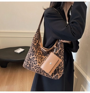 Detail of leopard print tote bag with attached camel leather pouch and metal button