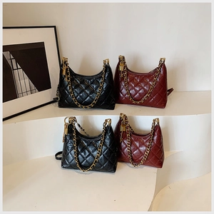 Elegant display of quilted leather handbags in black and burgundy with gold chain straps