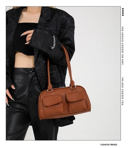 Detailed view of brown faux leather texture and silver buckle on the vintage shoulder bag