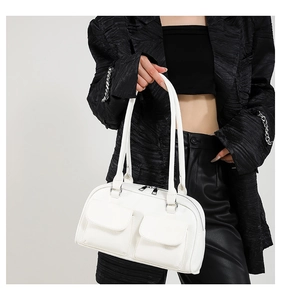 Detail of white PU leather shoulder bag with lychee texture and two front flap pockets