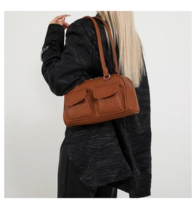 Rear view of model wearing a vintage brown PU leather shoulder bag with double front pockets