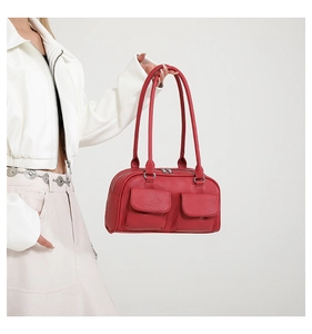 Detail view of red lychee grain leather underarm bag with double front flap pockets