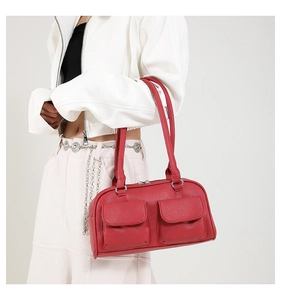 Detail of red PU leather underarm bag featuring two front flap pockets and zip closure
