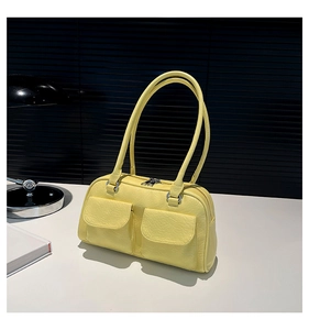 Detail view of pale yellow retro underarm bag featuring dual front flap pockets and matte PU texture