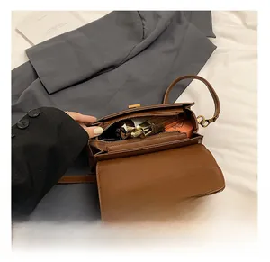 Interior view showing the storage capacity of the brown faux leather crossbody bag