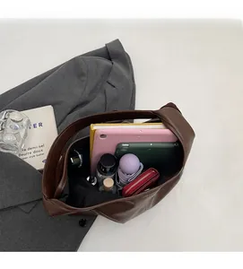 Interior view showing large capacity and compartments of the brown leather tote bag
