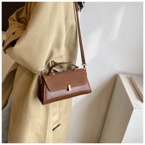 Brown PU matte shoulder bag styled with an elegant trench coat for a chic autumn look