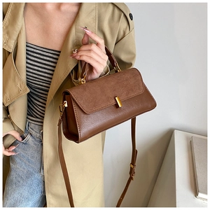 Detail view of brown matte PU leather shoulder bag with vintage gold metal buckle