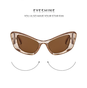 Close-up of champagne cat-eye sunglasses featuring glitter accents and tinted lenses