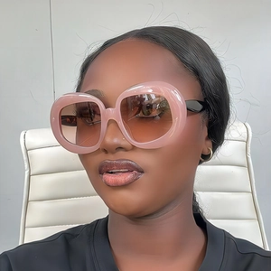 Retro oval oversized sunglasses with thick pink translucent frames and gradient lenses