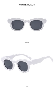 Detail view of white wavy-edge sunglasses with dark lenses from front and side angles
