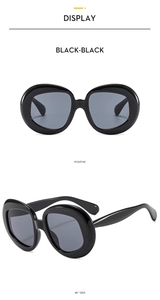 Close-up views of oval retro sunglasses in polished black frame from multiple angles
