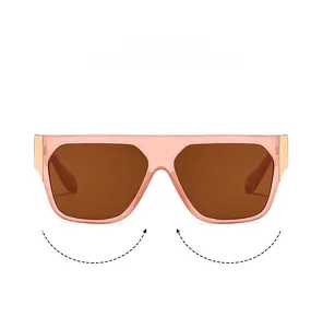 Detail of light pink transparent square frame sunglasses with gold metal hinge accents