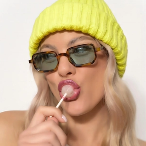 Retro small frame tortoiseshell sunglasses with neon yellow knitted beanie on a model