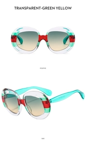 Detail view of oval retro sunglasses with green-yellow gradient lenses and striped frame