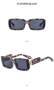 Detail view of flowers-black tortoise square sunglasses with gold metal hinges