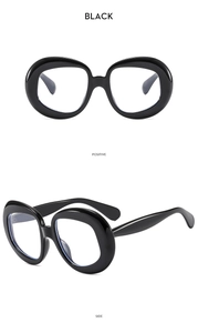 Detailed front and side views of chunky black oval sunglasses with thick frames