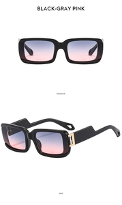 Detail of square sunglasses with black thick frames and gray-pink gradient lenses