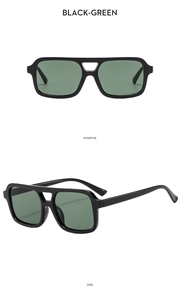 Close-up of retro square double-bridge sunglasses with black frames and green lenses