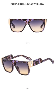 Detail of square oversized tortoiseshell sunglasses with purple gradient lenses and metal hinges
