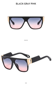 Detail view of square oversized sunglasses with black frame and black-gray pink gradient lenses