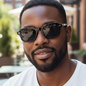Men's vintage square black sunglasses with silver accents worn outdoors for street style