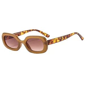 Retro oval sunglasses with translucent brown frames and tortoiseshell temples on white