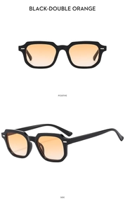 Close-up of retro square sunglasses with black frames and orange gradient lenses