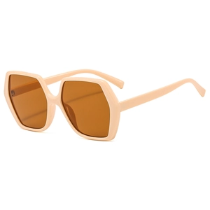 Lunettes de soleil hexagonales oversize avec monture beige nude et verres ambrés