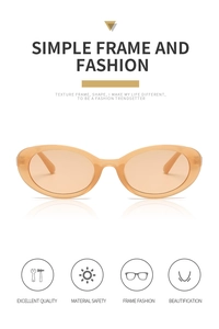 Detail view of orange oval sunglasses with translucent frame and modern cat-eye design