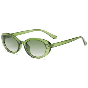 Vintage oval cat-eye sunglasses in translucent emerald green with gradient grey lenses