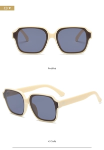 Detail view of beige polygon sunglasses with black inner rims and grey lenses