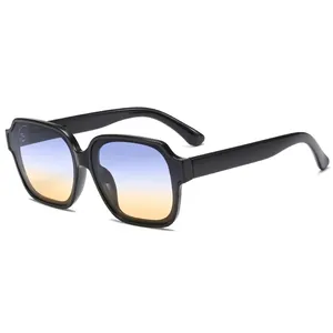 Fashionable oversized polygonal sunglasses with black frame and blue-orange gradient lenses
