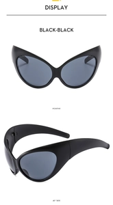 Macro detail of Y2K futuristic wrap sunglasses with matte black frames and dark lenses