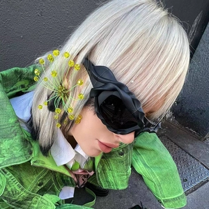 Macro side view of Y2K avant-garde black sunglasses with sculptural rose petal frames