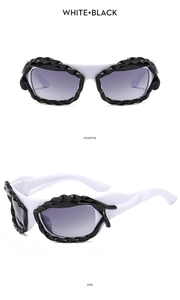 Y2K irregular sunglasses in white and black with twisted textured frame details