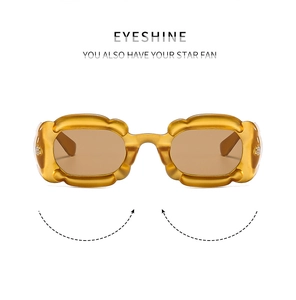 Front view of amber scalloped flower frame sunglasses with translucent brown lenses