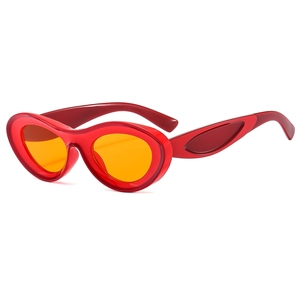 Y2K oval red translucent sunglasses with orange lenses in a trendy hip-hop style