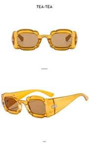 Detail of tea-colored petal sunglasses showing positive and side views in wavy frames